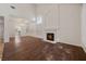 Spacious living room with high ceilings, fireplace, wood floors, and plenty of natural light at 5148 Forest Oaks Dr, Las Vegas, NV 89149