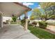 Covered patio offering a peaceful outdoor space with lush landscaping and views of the well-maintained backyard at 5148 Forest Oaks Dr, Las Vegas, NV 89149