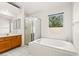 Bright bathroom with a large soaking tub, separate shower, and vanity, creating a serene and functional space at 5224 Dana Springs Way, Las Vegas, NV 89130