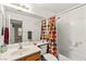 Bright bathroom features a tub with a shower and colorful curtain at 5224 Dana Springs Way, Las Vegas, NV 89130