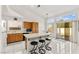 Bright kitchen features wood cabinets, white appliances, tiled floors, and a breakfast bar at 5224 Dana Springs Way, Las Vegas, NV 89130