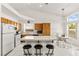 Bright kitchen features wood cabinets, white appliances, tiled floors, and a breakfast bar at 5224 Dana Springs Way, Las Vegas, NV 89130