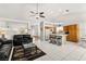 Open-concept living area with tile flooring flows seamlessly into the kitchen with a breakfast bar at 5224 Dana Springs Way, Las Vegas, NV 89130
