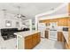 The open layout reveals a bright kitchen alongside a comfortable living room with hardwood floors at 5224 Dana Springs Way, Las Vegas, NV 89130