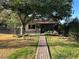 Secluded backyard featuring a charming brick pathway, mature trees, and a cozy outdoor seating area at 5352 Eugene Ave, Las Vegas, NV 89108