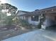 Beautiful home exterior featuring desert landscaping, mature trees, and a covered carport for added convenience at 5352 Eugene Ave, Las Vegas, NV 89108
