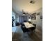 A dining area features a modern marble-top table, black chairs, and decorative wall art at 5365 Shake Ct # 103, Las Vegas, NV 89122