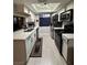 Modern kitchen featuring white cabinets, stainless steel appliances, and a skylight for natural light at 5365 Shake Ct # 103, Las Vegas, NV 89122