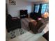 Cozy living room with comfortable seating, a TV, and a stylish patterned rug at 5365 Shake Ct # 103, Las Vegas, NV 89122