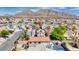 An aerial view of the home within a neighborhood, highlighting the surrounding streets and mountain views in the distance at 5853 Calobar Ln, Las Vegas, NV 89110