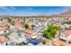 A high angle view of the home within a neighborhood, capturing the layout of the streets and mountain scenery at 5853 Calobar Ln, Las Vegas, NV 89110