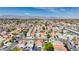 Residential area boasts many houses, verdant greenery, and distant city buildings under a bright blue sky at 5853 Calobar Ln, Las Vegas, NV 89110