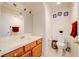 Cozy bathroom featuring tile countertops, oak cabinetry and neutral walls at 5853 Calobar Ln, Las Vegas, NV 89110