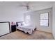 Bright bedroom featuring carpeted floors, a ceiling fan, and windows for natural light at 5853 Calobar Ln, Las Vegas, NV 89110