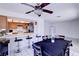 Bright dining area with tile floors, a ceiling fan, and an adjoining kitchen bar at 5853 Calobar Ln, Las Vegas, NV 89110