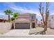 Charming two-story home with tile roof, desert landscaping, and attached two car garage at 5853 Calobar Ln, Las Vegas, NV 89110