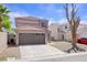 Charming two-story home with tile roof, desert landscaping, and attached two car garage at 5853 Calobar Ln, Las Vegas, NV 89110