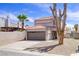 Charming two-story home with tile roof, desert landscaping, and attached two car garage at 5853 Calobar Ln, Las Vegas, NV 89110