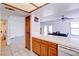 Bright kitchen featuring tile countertops, wood cabinets and views of the adjacent dining area at 5853 Calobar Ln, Las Vegas, NV 89110