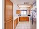 Classic style kitchen with warm wood cabinets and tile floors, creating a welcoming atmosphere at 5853 Calobar Ln, Las Vegas, NV 89110