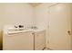 Bright laundry room featuring a white washer and dryer set next to a white door at 5853 Calobar Ln, Las Vegas, NV 89110