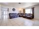 Bright, open living room boasts tile flooring, neutral walls, and a cozy seating arrangement at 5853 Calobar Ln, Las Vegas, NV 89110