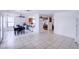Large combined living space with tile floors, a dining area and a kitchen bar at 5853 Calobar Ln, Las Vegas, NV 89110