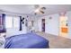 Bedroom featuring a ceiling fan, desk and door to walk in closet at 5853 Calobar Ln, Las Vegas, NV 89110