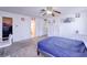 Carpeted bedroom with ceiling fan and door to bathroom at 5853 Calobar Ln, Las Vegas, NV 89110