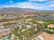 Scenic aerial view of a Gathering-friendly neighborhood with lush green spaces and stunning mountain views in the distance at 5889 Taylor Valley Ave, Las Vegas, NV 89131