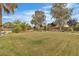 Expansive backyard featuring a manicured lawn and mature landscaping, offering a serene outdoor space at 5889 Taylor Valley Ave, Las Vegas, NV 89131
