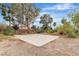 Wide shot of backyard showcasing concrete slab, rock ground cover and scattered landscaping at 5889 Taylor Valley Ave, Las Vegas, NV 89131