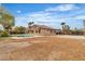 Expansive backyard features desert landscaping, refreshing pool and neutral stucco single-story home at 5889 Taylor Valley Ave, Las Vegas, NV 89131