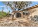 Neutral stucco single-story home with backyard featuring desert landscaping and a storage shed at 5889 Taylor Valley Ave, Las Vegas, NV 89131