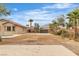 Wide shot of the backyard showcasing gravel yard, patio, landscaping, with a view of the house at 5889 Taylor Valley Ave, Las Vegas, NV 89131