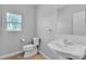 Neutral powder bathroom showcasing single sink vanity, a toilet, and a window at 5889 Taylor Valley Ave, Las Vegas, NV 89131