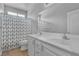 Bathroom featuring a dual sink vanity and a shower-tub combination with patterned curtain at 5889 Taylor Valley Ave, Las Vegas, NV 89131