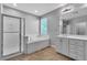 Bright bathroom featuring a bathtub, enclosed shower, and a dual sink vanity with white cabinets at 5889 Taylor Valley Ave, Las Vegas, NV 89131