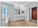 Bright Primary bathroom featuring tile floors, dual sinks, and separate tub at 5889 Taylor Valley Ave, Las Vegas, NV 89131