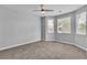 Bright bedroom with neutral walls, carpet, ceiling fan, and dual windows at 5889 Taylor Valley Ave, Las Vegas, NV 89131
