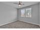 Neutral bedroom with carpet, ceiling fan, and a bright window at 5889 Taylor Valley Ave, Las Vegas, NV 89131