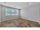 Bright bedroom with tile flooring, large windows, and neutral paint for a modern aesthetic at 5889 Taylor Valley Ave, Las Vegas, NV 89131