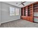 Bedroom features a ceiling fan, built in shelves and cabinets, and large windows at 5889 Taylor Valley Ave, Las Vegas, NV 89131