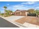 Charming single-story home featuring mature landscaping, a three-car garage, a gated driveway and desert landscaping at 5889 Taylor Valley Ave, Las Vegas, NV 89131