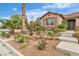 Charming single-story home boasts lush landscaping, decorative rock and manicured desert plants in the front yard at 5889 Taylor Valley Ave, Las Vegas, NV 89131
