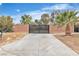 Private gated driveway featuring desert landscaping with a spacious driveway and a contemporary design at 5889 Taylor Valley Ave, Las Vegas, NV 89131