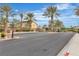 Well-maintained community entrance with black wrought iron gates and manicured landscaping for a secure environment at 5889 Taylor Valley Ave, Las Vegas, NV 89131