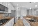 Modern kitchen featuring granite counters, white cabinets, and stainless steel appliances at 5889 Taylor Valley Ave, Las Vegas, NV 89131