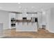 Open kitchen featuring stainless appliances, granite countertops, white cabinets, and breakfast bar at 5889 Taylor Valley Ave, Las Vegas, NV 89131