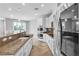 Bright kitchen featuring stainless appliances, granite countertops, and white cabinets at 5889 Taylor Valley Ave, Las Vegas, NV 89131